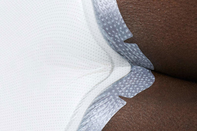 Biatain Silicone Fit tapered edges and twin tips adhering to the gluteal cleft.