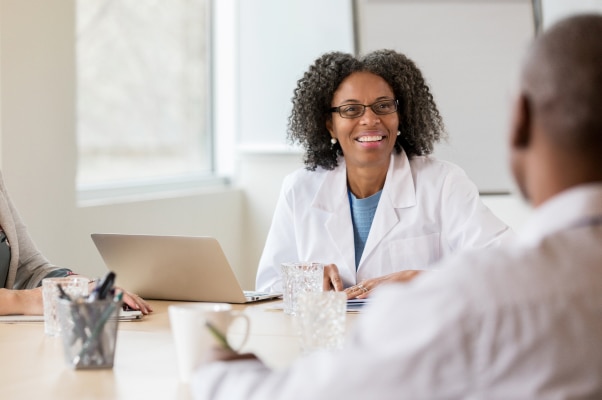 Female physician smiling at man